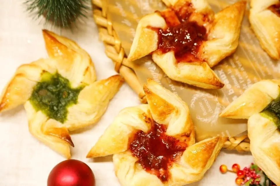 天板にオーブン用シートを敷き、①を並べる。ジャムを中央にのせて全体に粉糖をたっぷりとかけ、オーブンで約10分焼く。